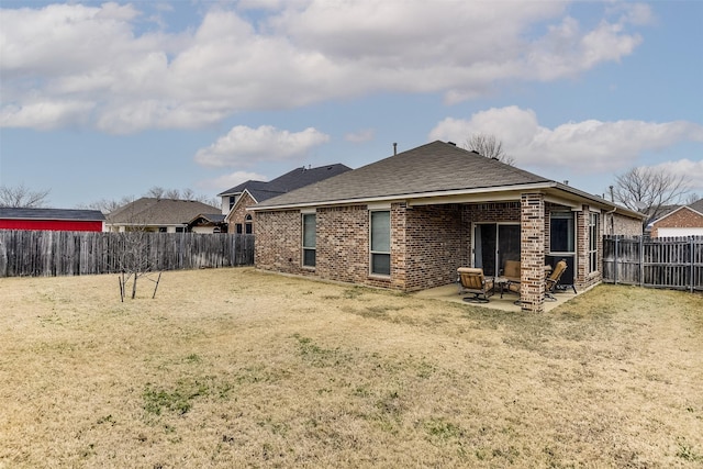 back of house featuring a patio area and a yard