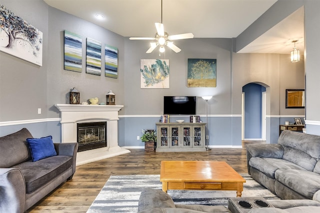 living room featuring ceiling fan and wood-type flooring