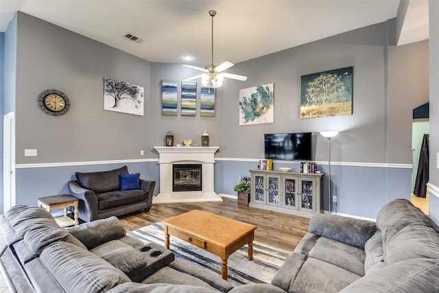 living room featuring ceiling fan and wood-type flooring