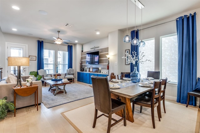 dining area with ceiling fan, plenty of natural light, and light hardwood / wood-style floors