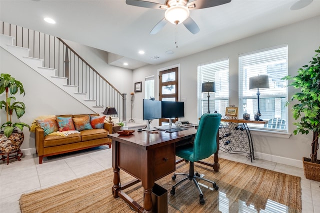 tiled office space featuring ceiling fan and a healthy amount of sunlight