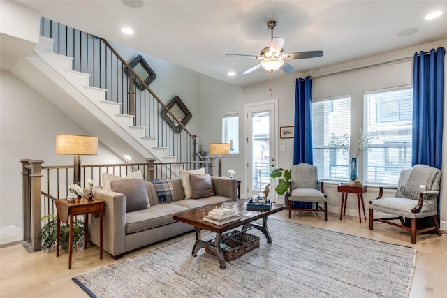 living room featuring ceiling fan and light hardwood / wood-style floors