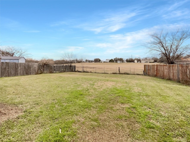 view of yard with a rural view