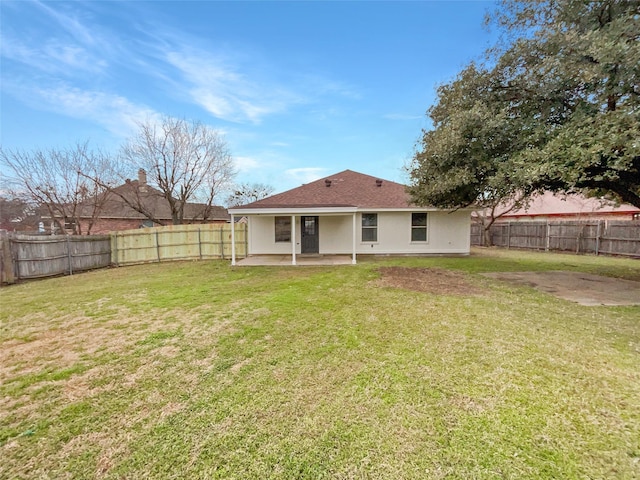 back of property featuring a patio area and a yard