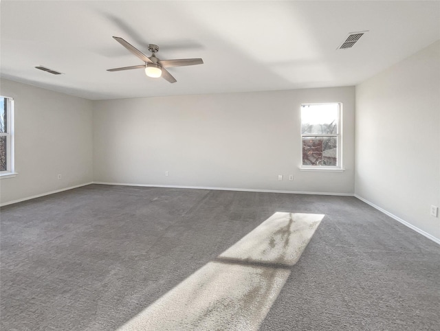 carpeted spare room with ceiling fan