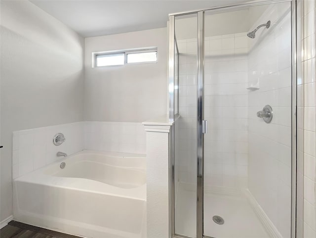 bathroom featuring hardwood / wood-style flooring and plus walk in shower