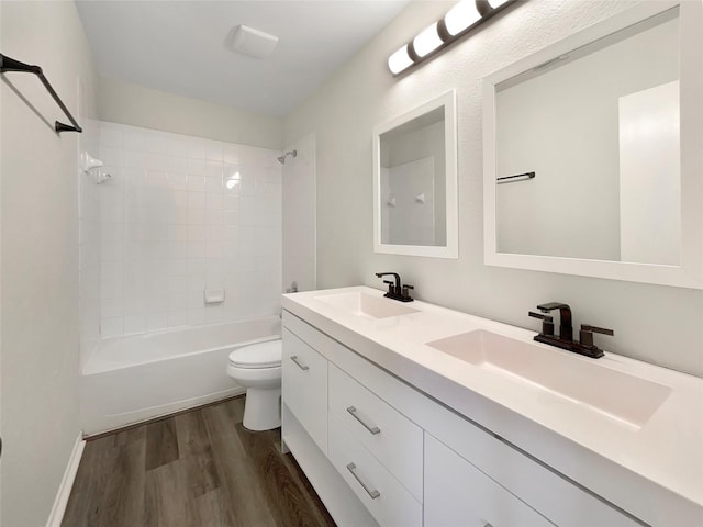 full bathroom with tub / shower combination, hardwood / wood-style floors, toilet, and vanity