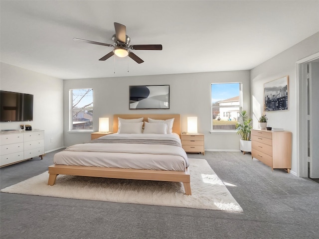 bedroom with ceiling fan, carpet flooring, and multiple windows