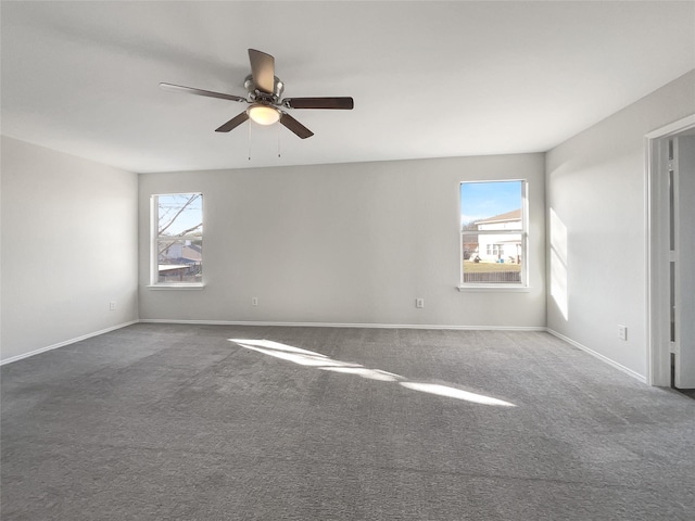 spare room featuring a healthy amount of sunlight, carpet flooring, and ceiling fan