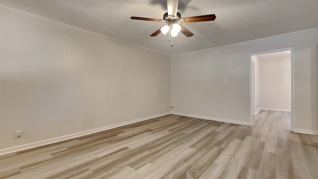 spare room featuring ceiling fan, ornamental molding, a textured ceiling, and light hardwood / wood-style flooring