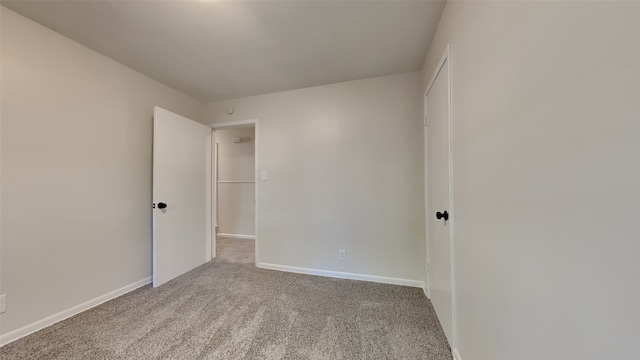 spare room featuring light colored carpet