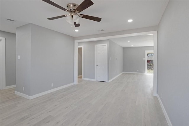 empty room with recessed lighting, light wood-style flooring, and baseboards