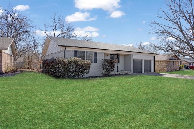 single story home with a garage, aphalt driveway, a front lawn, and brick siding