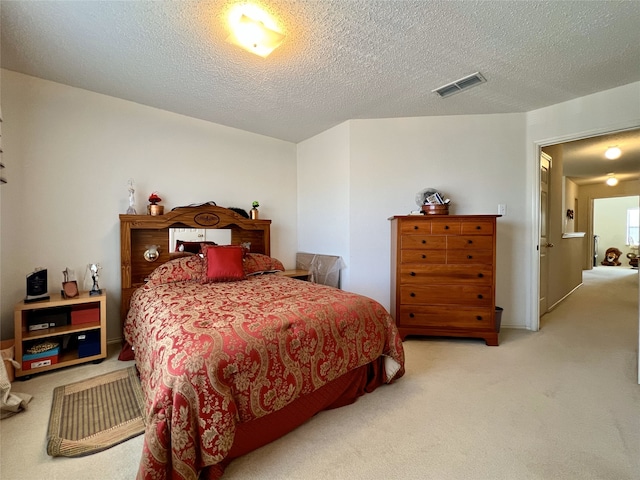 carpeted bedroom featuring a textured ceiling