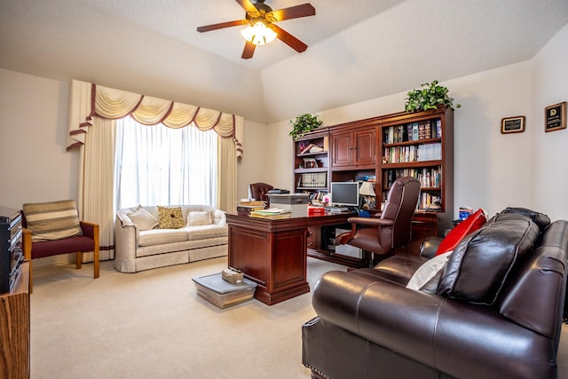 home office featuring ceiling fan, light carpet, and lofted ceiling