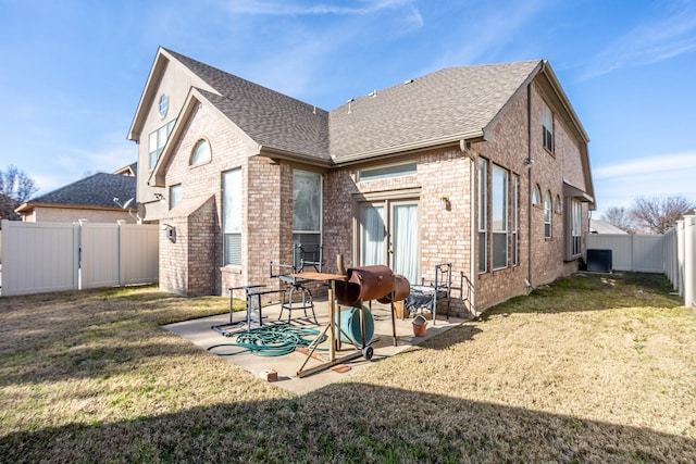 back of house with central AC, a lawn, and a patio