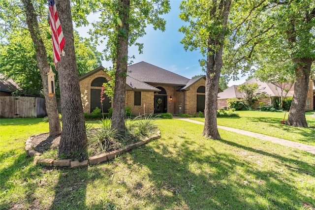 ranch-style home with a front lawn