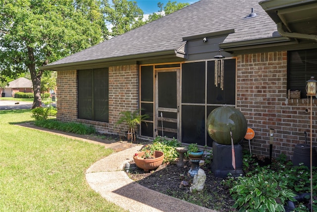 entrance to property featuring a lawn