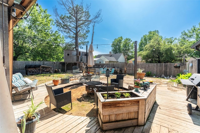 wooden deck featuring an outdoor fire pit