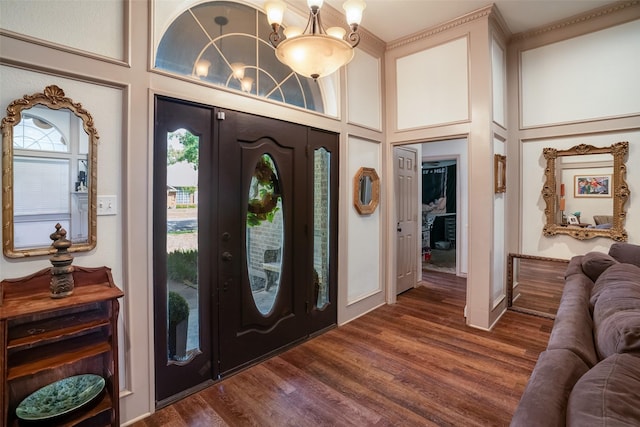 entrance foyer featuring a high ceiling, dark hardwood / wood-style floors, and a notable chandelier