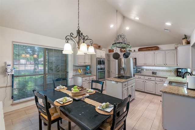 kitchen with appliances with stainless steel finishes, backsplash, a center island, white cabinets, and sink