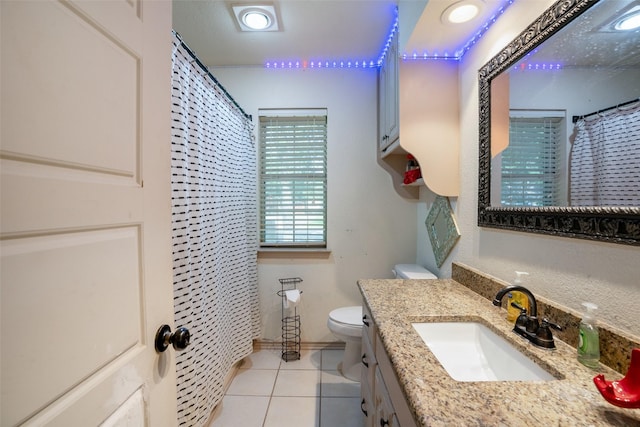 bathroom featuring toilet, vanity, and tile patterned flooring