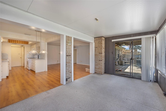 unfurnished living room featuring light colored carpet