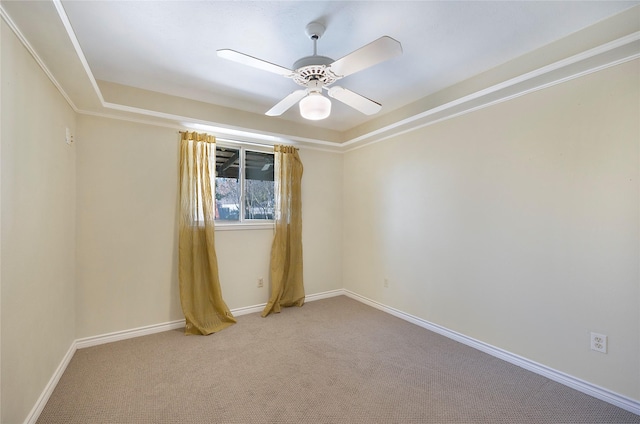 carpeted spare room with ceiling fan and ornamental molding