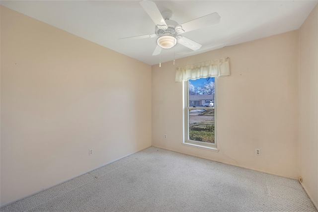 spare room featuring ceiling fan and light colored carpet