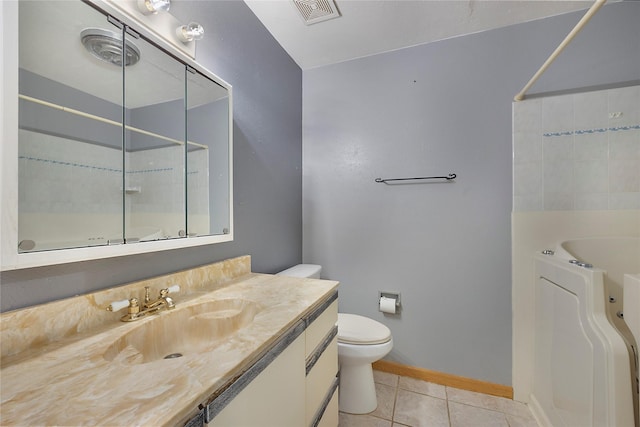 bathroom with toilet, a tub to relax in, tile patterned floors, and vanity