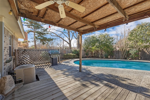 view of swimming pool with ceiling fan, a grill, a deck, and cooling unit