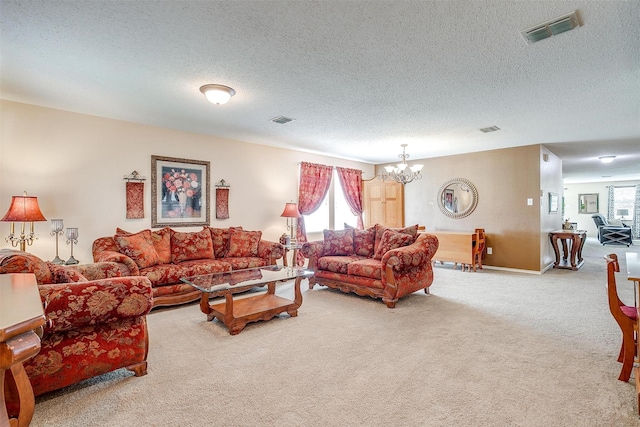 carpeted living room with a textured ceiling, plenty of natural light, and a notable chandelier