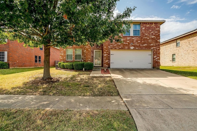 traditional home with a garage, a front yard, concrete driveway, and brick siding