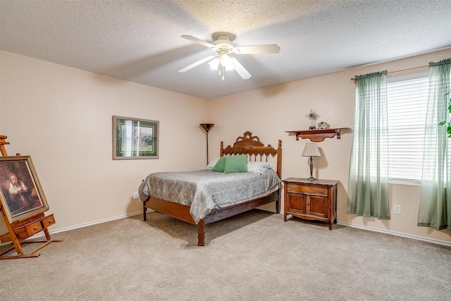 carpeted bedroom with ceiling fan and a textured ceiling