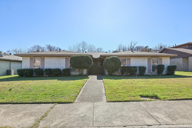 ranch-style house with a front lawn and central AC unit