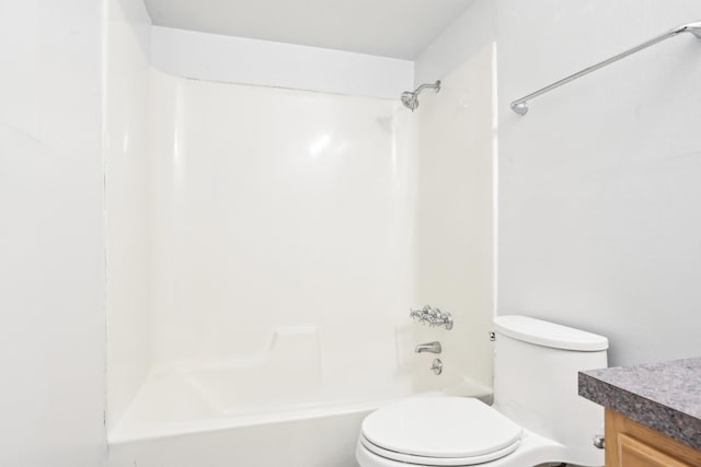 full bathroom with toilet, vanity, and washtub / shower combination