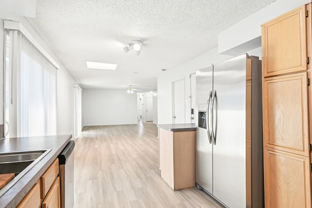 kitchen with ceiling fan, light brown cabinetry, light wood-type flooring, and stainless steel appliances