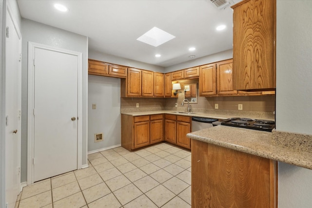 kitchen with light tile patterned flooring, a skylight, a sink, backsplash, and brown cabinetry