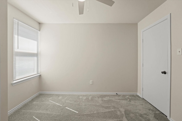 unfurnished room featuring a ceiling fan, carpet, and baseboards