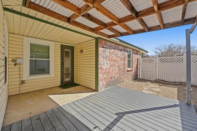 wooden deck featuring fence and a patio