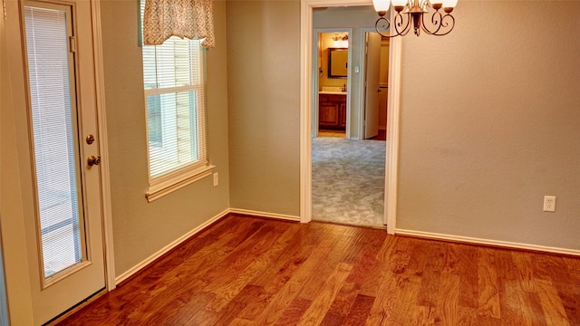 interior space featuring a chandelier and hardwood / wood-style flooring