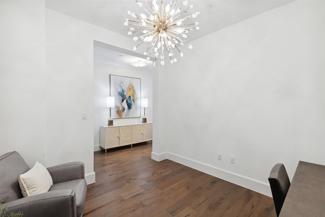 living area with dark hardwood / wood-style flooring and a notable chandelier