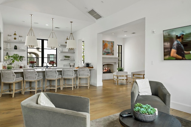 living room with vaulted ceiling and hardwood / wood-style flooring