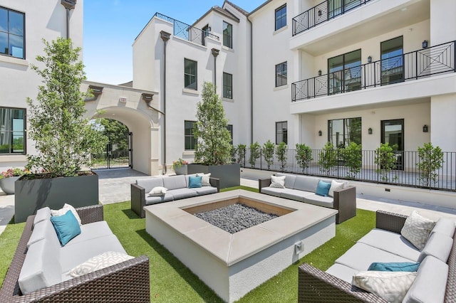 exterior space with an outdoor living space with a fire pit