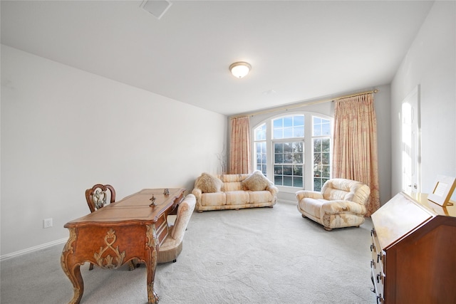 sitting room featuring light colored carpet