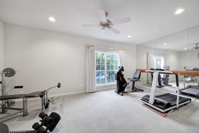 workout area featuring ceiling fan and light colored carpet