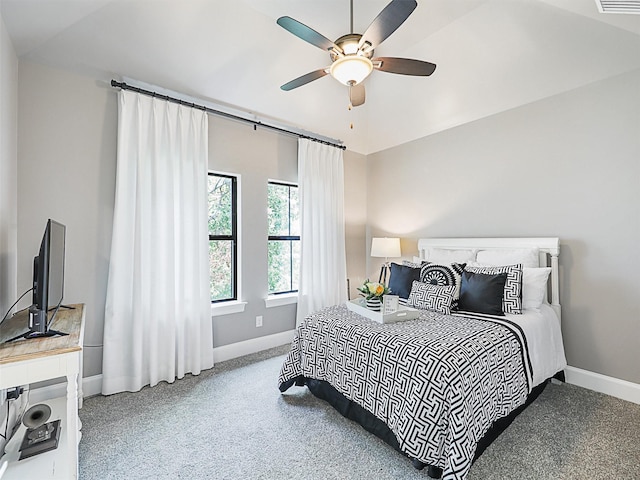 bedroom featuring ceiling fan, vaulted ceiling, and carpet flooring