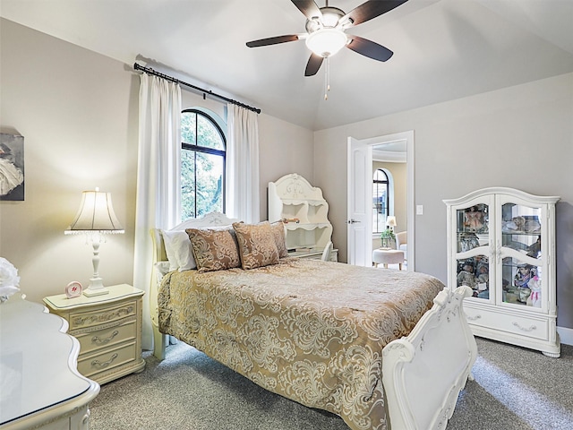 carpeted bedroom featuring ceiling fan and vaulted ceiling