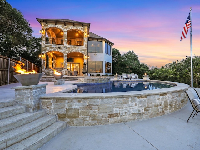 pool at dusk with a patio