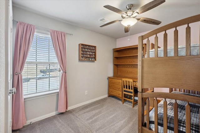 bedroom featuring ceiling fan, carpet floors, and multiple windows